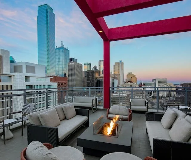 A rooftop patio with a fire pit and a view of the city, perfect for a Winston-Salem wedding venue.