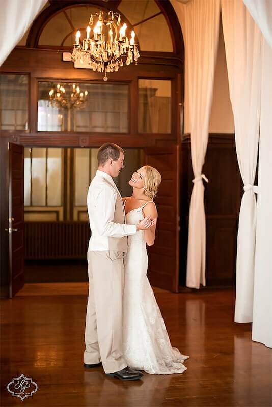 A bride and groom elegantly dance in a spacious Winston-Salem wedding venue.