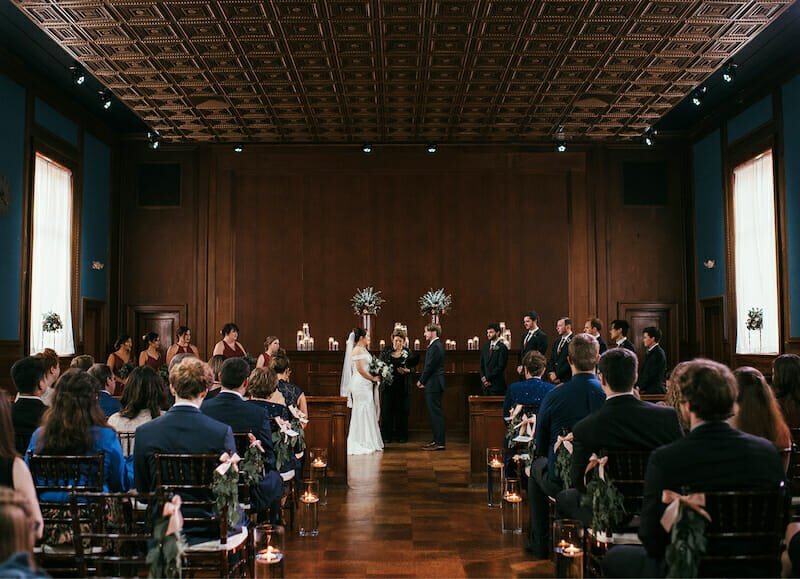 A winston-salem wedding ceremony in a large room at an elegant venue.