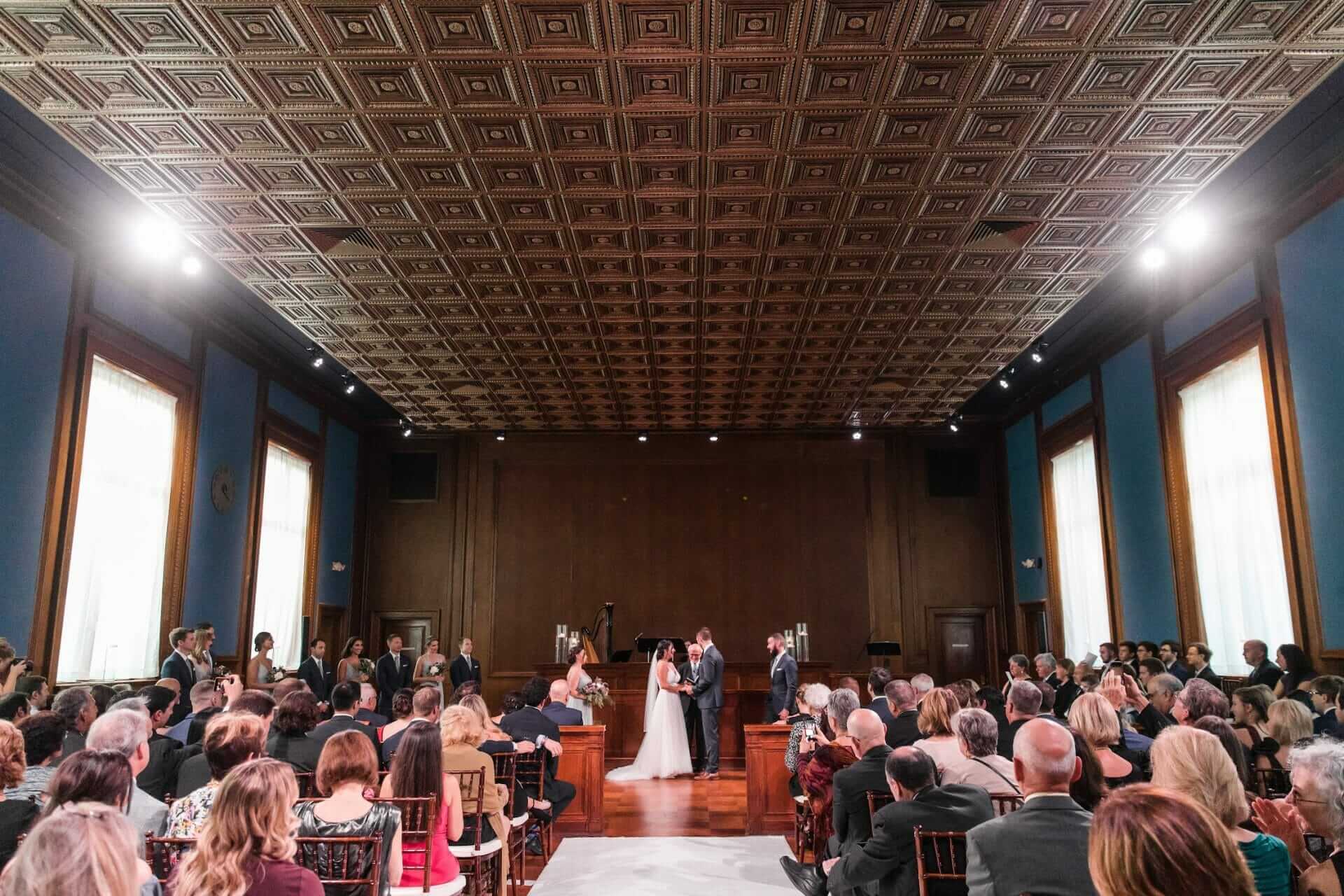 A beautiful Winston-Salem wedding ceremony in a large room with large windows.